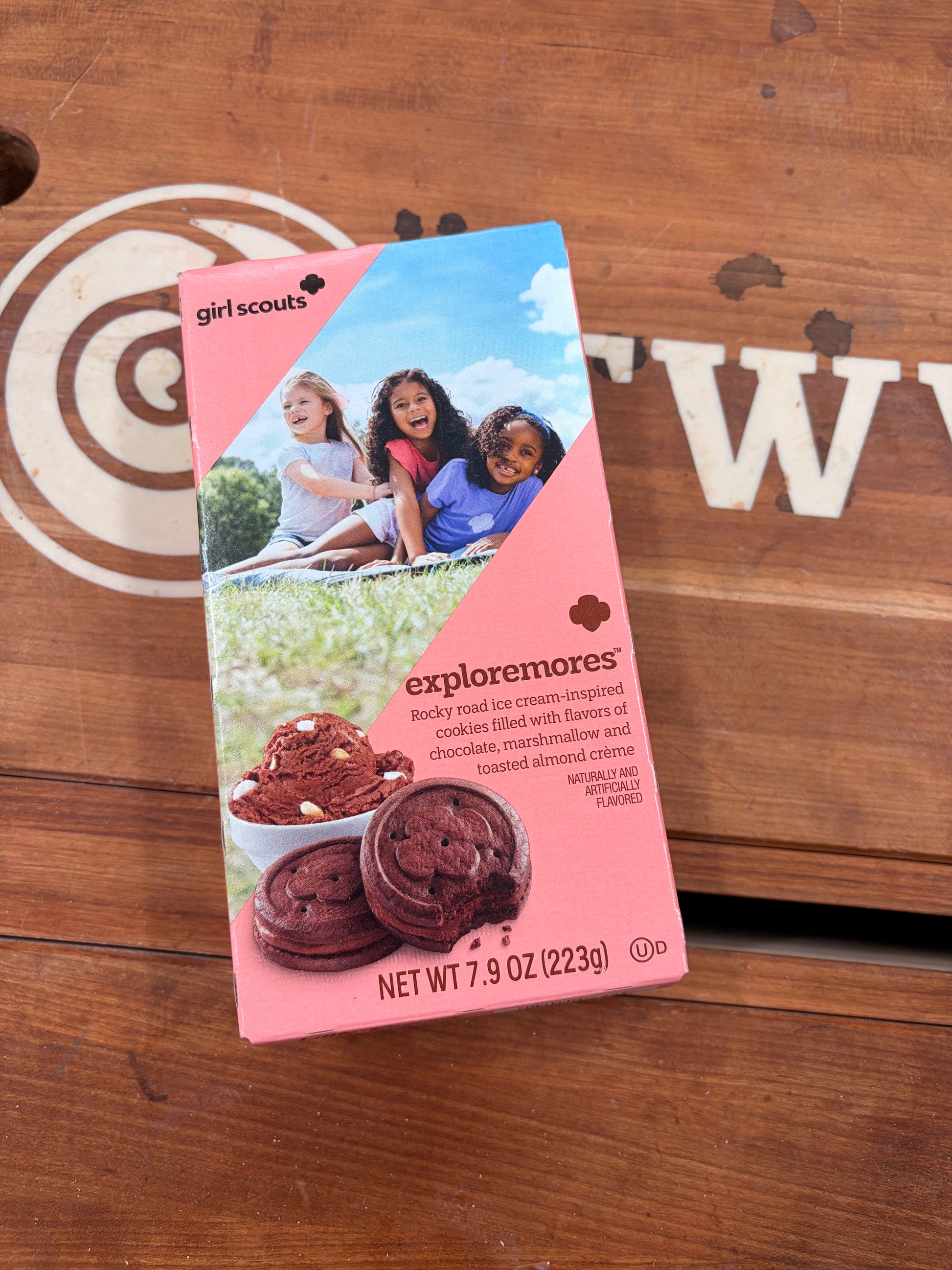 Girl Scouts Exploremore cookies package on a wooden surface